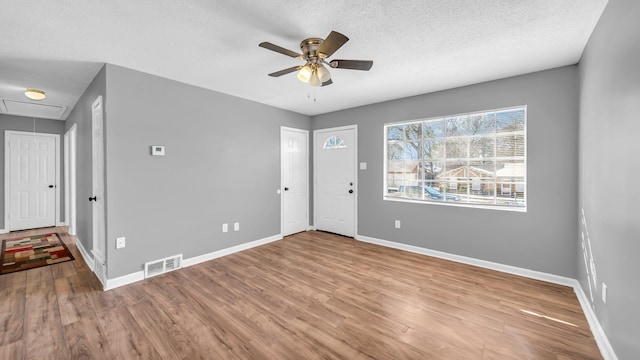 spare room featuring a textured ceiling, ceiling fan, and hardwood / wood-style floors