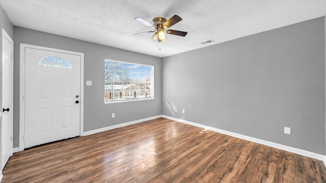 entryway with ceiling fan, a textured ceiling, and dark hardwood / wood-style floors