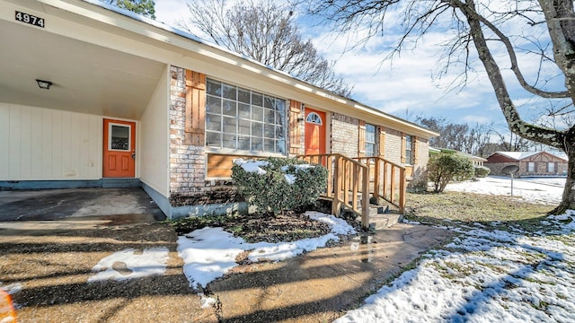 view of snow covered property entrance