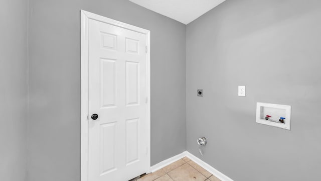 laundry area featuring washer hookup, electric dryer hookup, and light tile patterned flooring