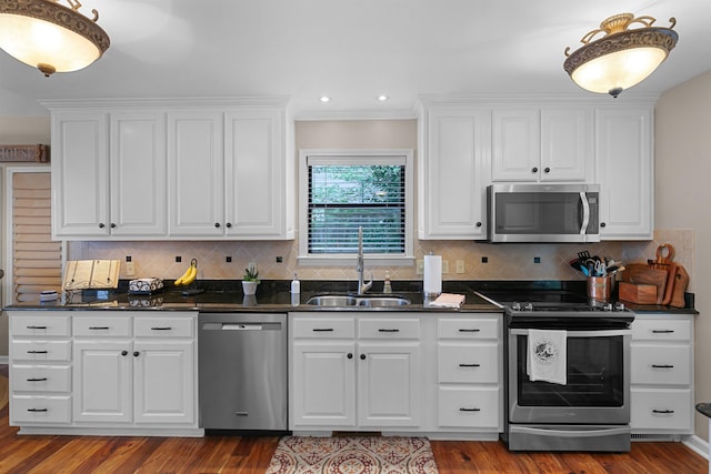 kitchen with hardwood / wood-style flooring, stainless steel appliances, crown molding, white cabinets, and sink