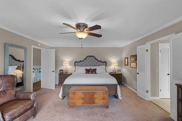 carpeted bedroom featuring ceiling fan and ornamental molding