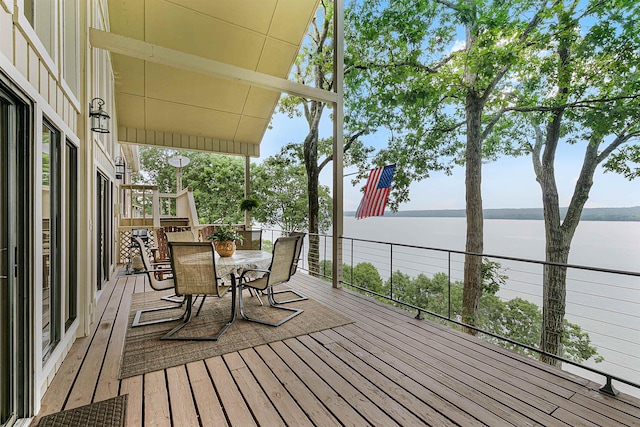 wooden terrace featuring a water view