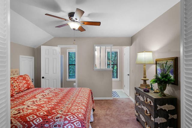 bedroom with ceiling fan, lofted ceiling, and carpet floors