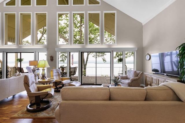 living room with hardwood / wood-style flooring, high vaulted ceiling, and crown molding