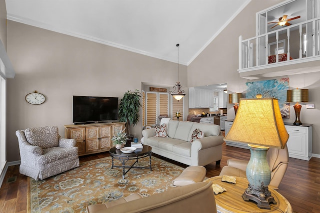 living room with ceiling fan, ornamental molding, dark hardwood / wood-style floors, and high vaulted ceiling