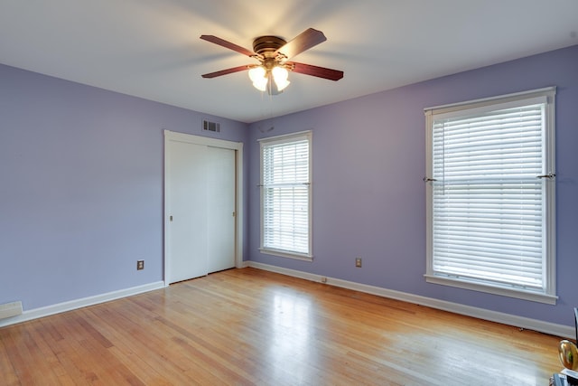 empty room featuring light wood-type flooring and ceiling fan