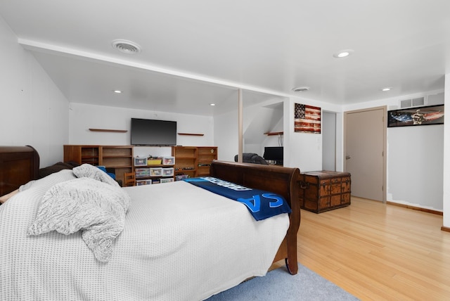 bedroom with hardwood / wood-style floors