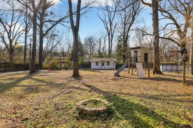 view of yard featuring a playground and an outbuilding