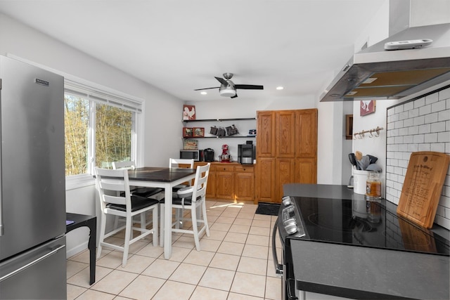 kitchen featuring ceiling fan, appliances with stainless steel finishes, extractor fan, and light tile patterned flooring