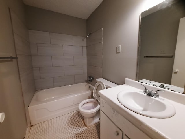 full bathroom featuring toilet, tiled shower / bath, tile patterned flooring, a textured ceiling, and vanity