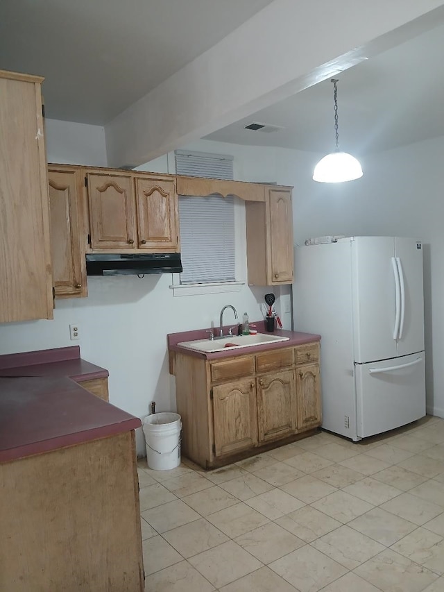 kitchen with sink, decorative light fixtures, and white refrigerator