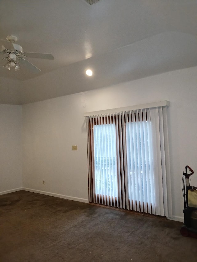 unfurnished room with ceiling fan and dark colored carpet