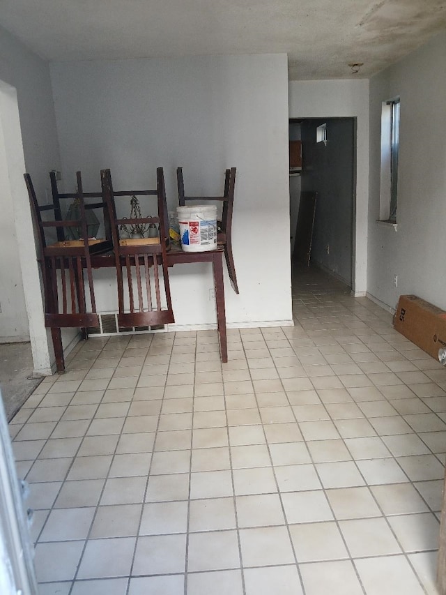 dining area featuring light tile patterned flooring