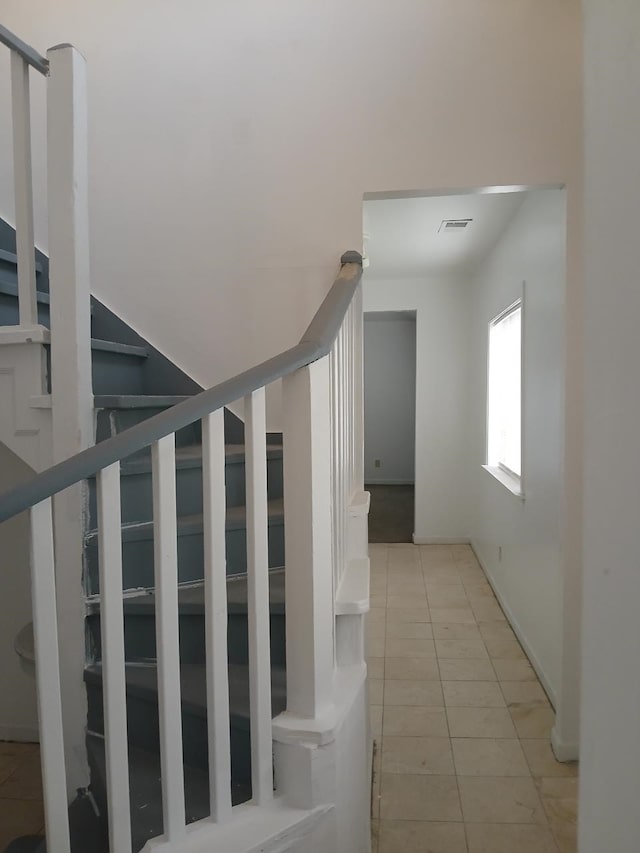 staircase featuring tile patterned floors