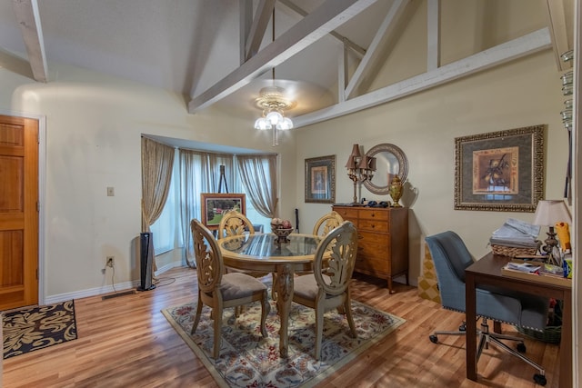 dining area with hardwood / wood-style flooring, high vaulted ceiling, beam ceiling, and ceiling fan