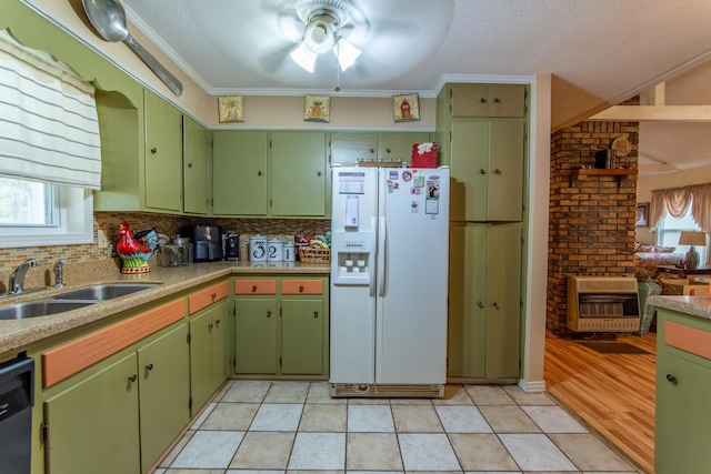 kitchen with dishwasher, sink, heating unit, ornamental molding, and white fridge with ice dispenser