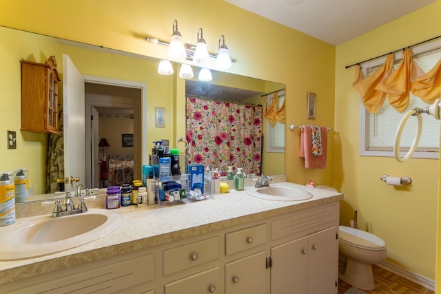 bathroom with toilet, a shower with shower curtain, vanity, and parquet flooring