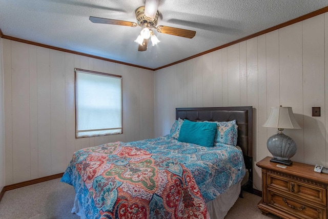 carpeted bedroom with ceiling fan, a textured ceiling, crown molding, and wood walls