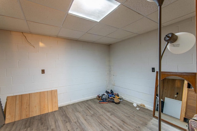 spare room with a paneled ceiling and hardwood / wood-style floors