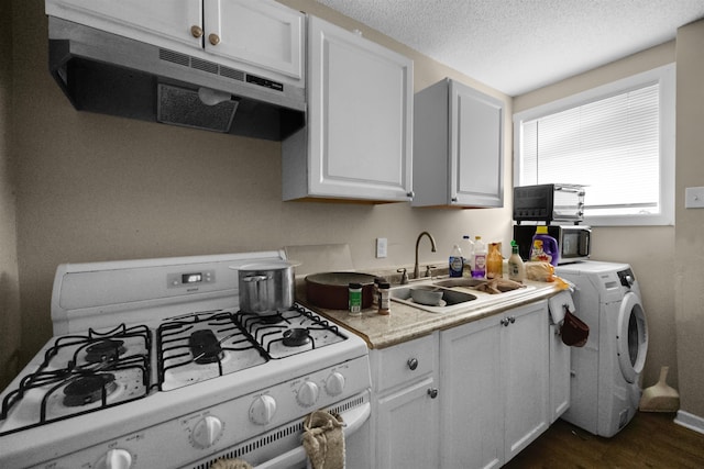 kitchen with sink, white cabinetry, gas range gas stove, and washer / dryer