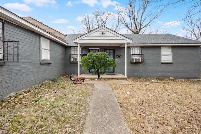 doorway to property with a lawn