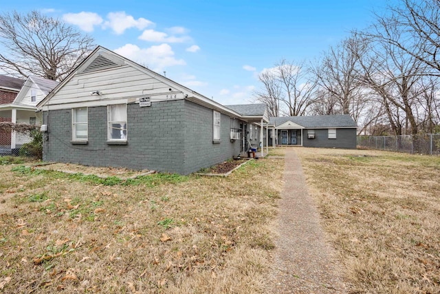 view of side of home with a yard