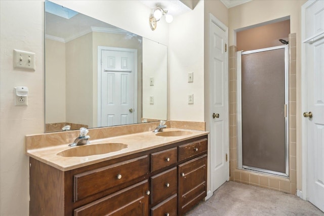 bathroom featuring a skylight, a shower with door, crown molding, and vanity