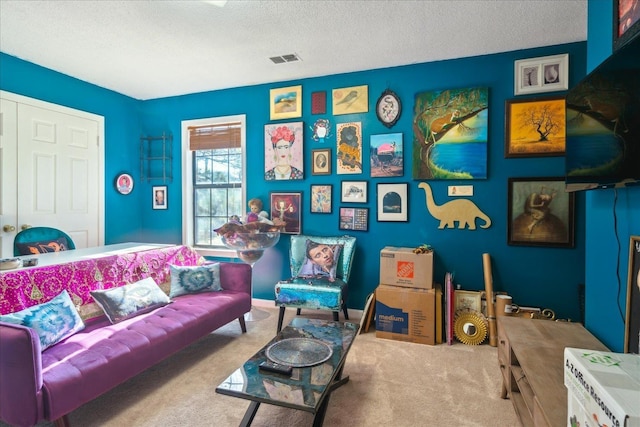 sitting room featuring a textured ceiling and carpet flooring