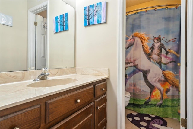 bathroom with toilet and vanity