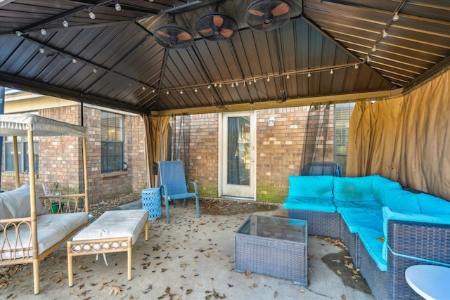 view of patio / terrace featuring ceiling fan, a gazebo, and an outdoor hangout area