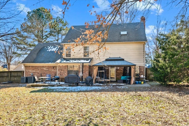 back of property featuring a patio area, a gazebo, and cooling unit