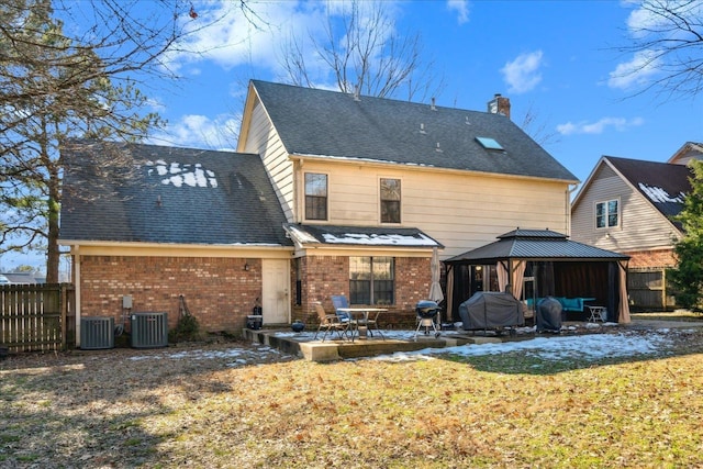 back of house with central AC unit, a patio area, a gazebo, and a lawn