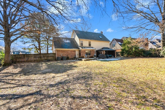 back of house featuring a gazebo and a lawn