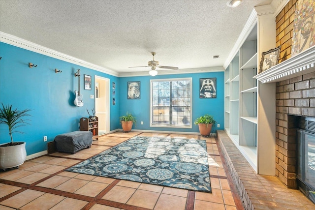 living room with built in shelves, ceiling fan, ornamental molding, light tile patterned flooring, and a brick fireplace