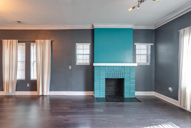 unfurnished living room featuring a textured ceiling, dark hardwood / wood-style floors, crown molding, and a fireplace