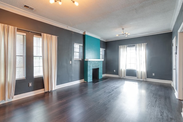 unfurnished living room featuring a brick fireplace, plenty of natural light, crown molding, and a textured ceiling