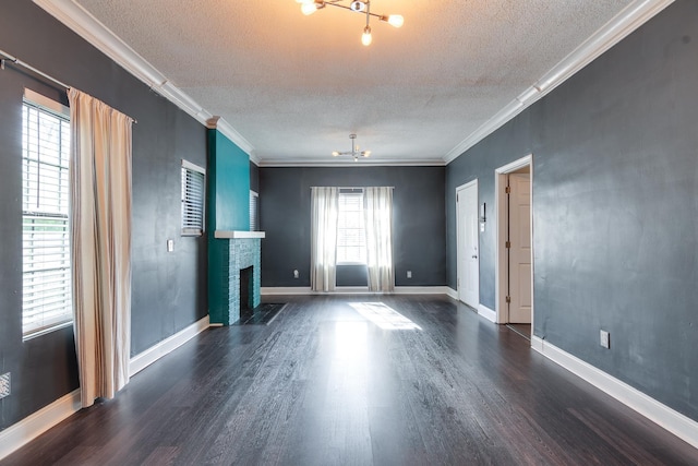 unfurnished living room with a healthy amount of sunlight, a fireplace, ornamental molding, and a textured ceiling