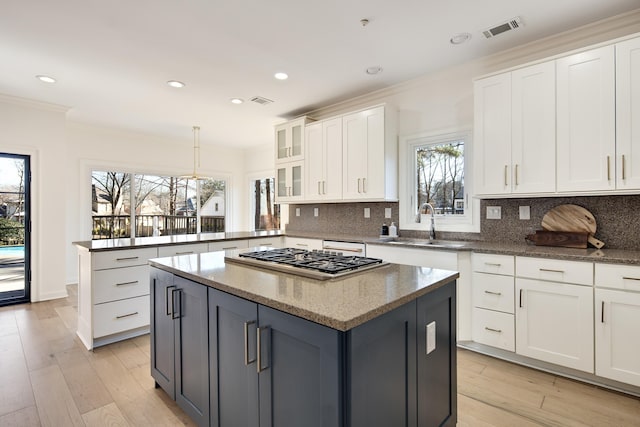 kitchen with white cabinetry, gray cabinetry, kitchen peninsula, and a kitchen island