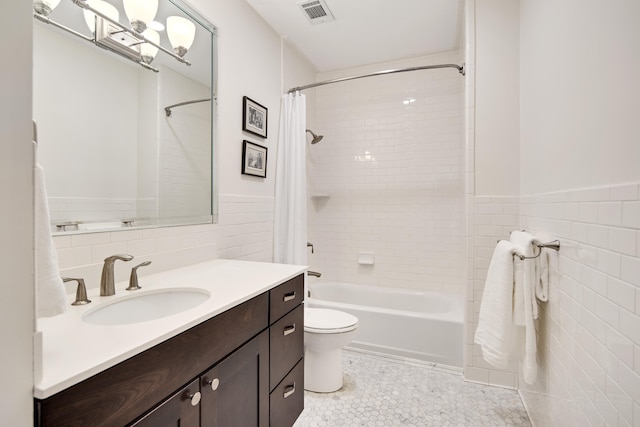 full bathroom featuring toilet, tile walls, tile patterned floors, shower / tub combo, and vanity