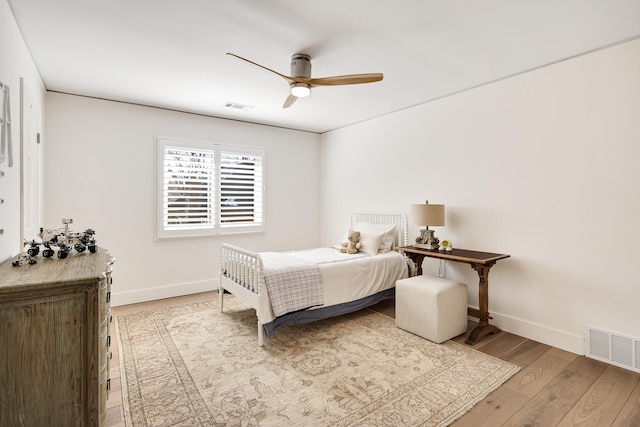 bedroom with ceiling fan and wood-type flooring