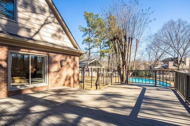 wooden terrace with a gazebo and a swimming pool