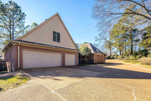 view of home's exterior featuring an outdoor structure and a garage