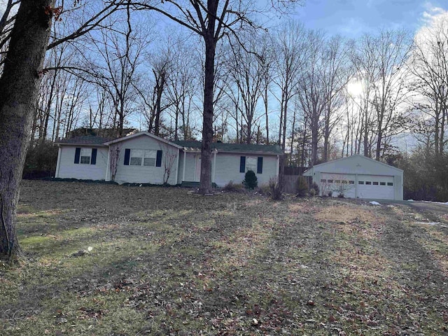 single story home featuring a garage and an outbuilding