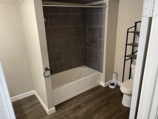 bathroom featuring toilet, tiled shower / bath, and hardwood / wood-style floors