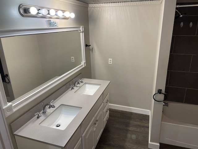 bathroom featuring wood-type flooring, vanity, and  shower combination