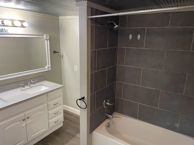 bathroom featuring tiled shower / bath, vanity, and hardwood / wood-style floors