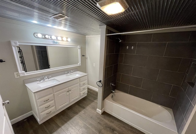 bathroom featuring tiled shower / bath, vanity, and hardwood / wood-style flooring