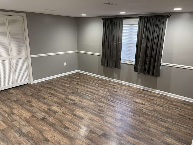 unfurnished room with dark hardwood / wood-style flooring