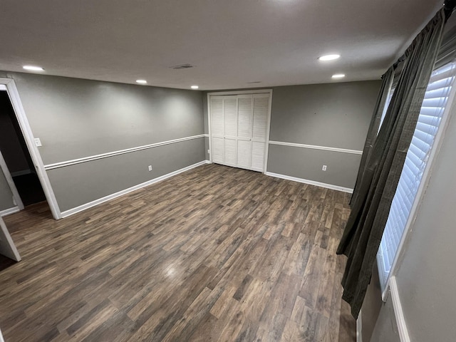 interior space with a closet and dark hardwood / wood-style flooring